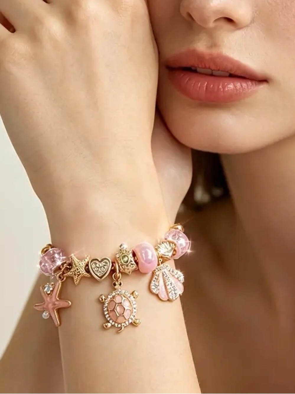 Gold-Tone Pink Sea Charm Bracelet.